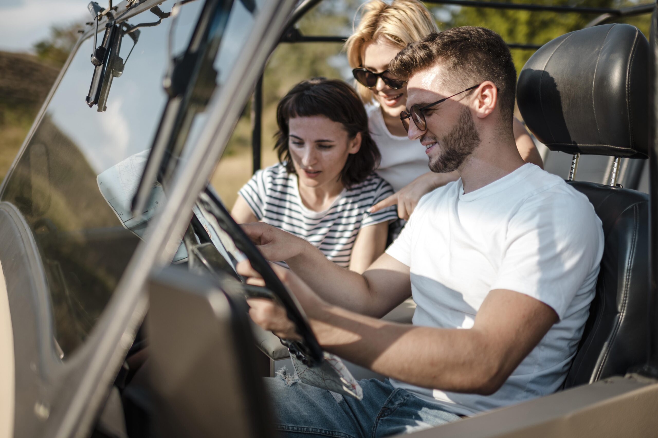 man-female-friends-checking-map-while-traveling-by-car